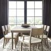 Ridge Dining Arm Chair styled in a spacious dining room with matching chairs and table on patterned rug