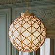 Polyhedron Pendant glowing warmly in green room with floral wall molding and window in background