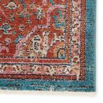 Zoomed-in corner highlighting intricate pattern and teal edge finish with visible rug fringes