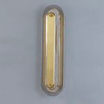 Vertical wall sconce mounted on a gray wall showing overall shape and design