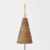 Front view focusing on woven rattan shade with black cord hanging down