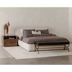 Colin king bed dressed with dark gray bedding beside wooden nightstand and bench on a light rug