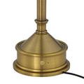 Close-up of brass base with on/off button and power cord unplugged