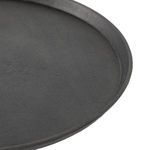 Side angle showing curvature of iron tray edge perched above white marble base