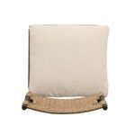 Top-down view of beige cushion resting on woven wicker seat