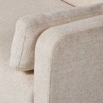 Angled close view of Toland sectional's front armrest with loose cylindrical cushion