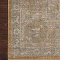 Corner close-up showing texture and detailed pattern of Rosemarie Gold/Sand rug on dark wood floor