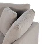 Close-up on armrest with plush angled back pillows