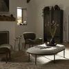 Two olive chenille chairs in natural light living space with soft area rug and decor accents
