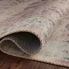 Close-up of rug folded over, revealing tightly woven polyester texture and stitched edging