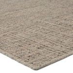 Close-up on ridged weave and fiber texture of brown and taupe Vidalia rug corner