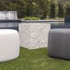 White and dark gray Pebble End Tables with textured square table in outdoor grass setting by pool