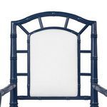 Close-up of upper backrest showing bamboo-style frame with white fabric upholstery in Delia Armchair