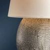 Side angle close-up highlighting texture and pattern on spherical ceramic lamp base