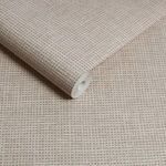 Close-up view of rolled Rustic Weft Wallpaper highlighting textured weave and creamy color