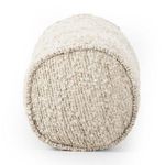 Rounded end of bolster with visible edge piping and boucle knit detail