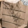 Laguna Dining Chair backrest with shadows of surrounding plants in warm indoor setting