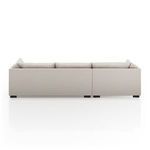 Rear view of sectional showing smooth upholstery and compact block legs in espresso finish