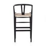 Side view on white background focusing on black teak frame and woven seat detail
