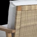 Detailed view of resin wicker weaving pattern at chair back corner with teak frame
