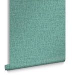 Rolled wallpaper showing texture and subtle color variations in navy and soft blue