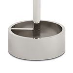 Close-up of round polished metal base showing inner cross support and sleek finish