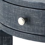 Close-up of silver knob and front edge of navy drawer highlighting textured finish