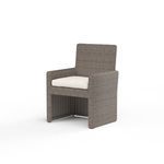 Coronado Dining Chair in Driftwood resin wicker with plush cream cushion and straight, transitional lines