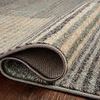 Folded corner close-up revealing thin texture and polypropylene weave of the rug on wooden floor
