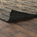 Side view showing rug edge lifted to reveal woven underside and layered fiber construction