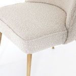 Detailed close-up of seat cushion texture with brass leg below
