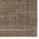 Detailed view of multi-layered geometric border and corner patterns in brown and cream