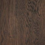 Dark solid oak wood grain texture of the table base in close-up