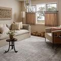 Hollis Smoke / Mist Rug styled in a neutral living room with sofas and natural light through windows