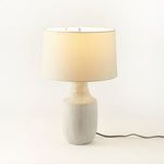 Interior view under lamp shade showing bulb socket and switch on checked-patterned neck.