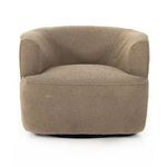 Front view with subtle lighting emphasizing chair's rounded shape and fabric texture