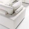 Close-up on corner of modular sectional showing bolster pillow and cushion arrangement
