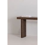 Close-up of Monterey console table panel leg with stacked books on tabletop in neutral interior