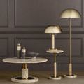 Lubo Breccia bowl on low marble table with candles and brass lamps near dark paneled wall