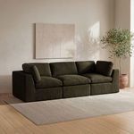Cates Slipper Chair shown as part of a dark olive sectional sofa in neutral living room