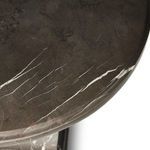 Macro shot of marble pattern on tabletop edge illustrating fine white veins and dark grey surface