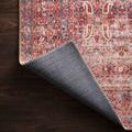 Corner of Loren rug flipped to expose woven backside in dark gray with stitched edge