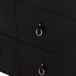 Close-up of two black dresser drawers with metal ring pulls aligned horizontally