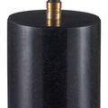 Close-up of polished black marble base reflecting light with a brass fitting at top