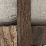 Close-up detail of metal frame texture and stitching under seat cushion
