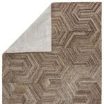 Rug with one corner lifted, revealing solid light gray wool backing on underside