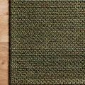 Rug corner on wooden floor highlighting weave detail and color variation