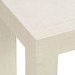 Close-up detail of raffia texture on table’s corner and leg junction in white finish