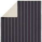 Close-up image showing corner fold of the rug back exposing the soft cream underside