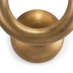 Detailed view of round brass mounting plate with warm golden brushed metal finish under sconce arms